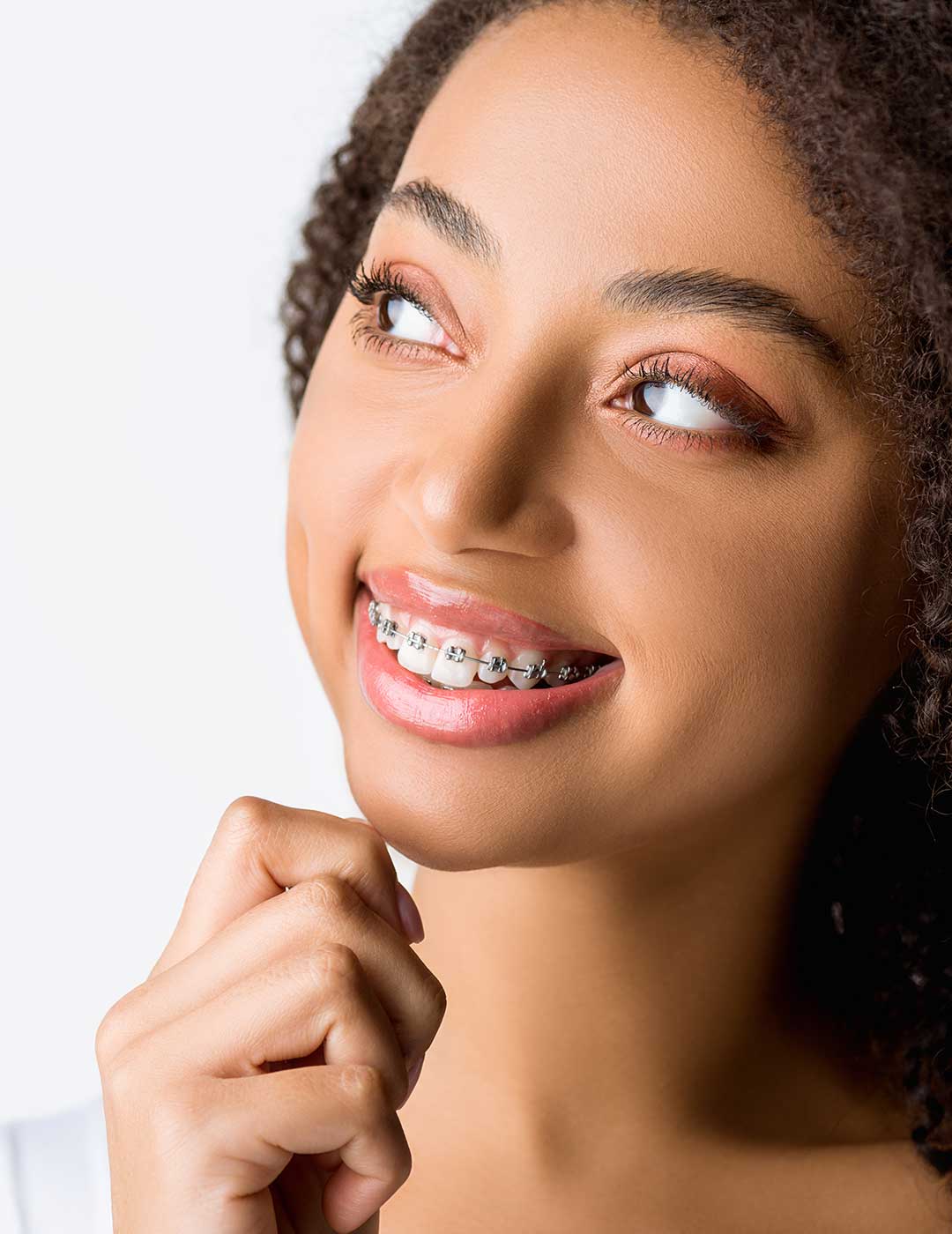 A closeup of a female patient at Harmony Medical Center wearing modern braces.