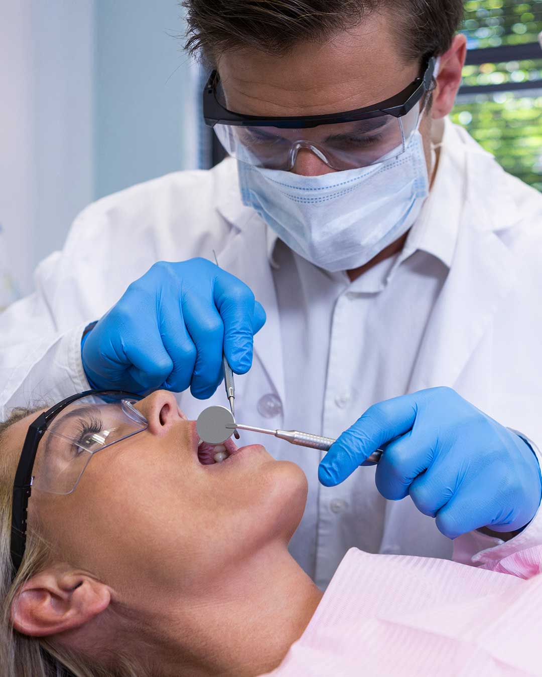 Specialist periodontist at Harmony Medical Center checks patient for signs of gum disease