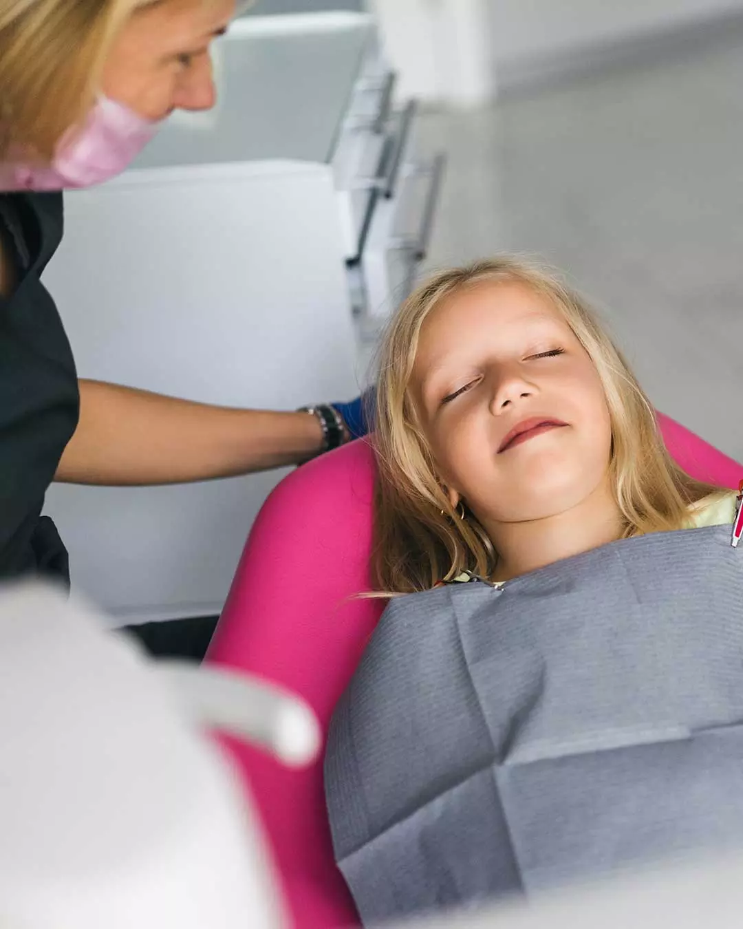 Young girl with her eyes closed relaxed during her dental treatment at Harmony Medical Center
