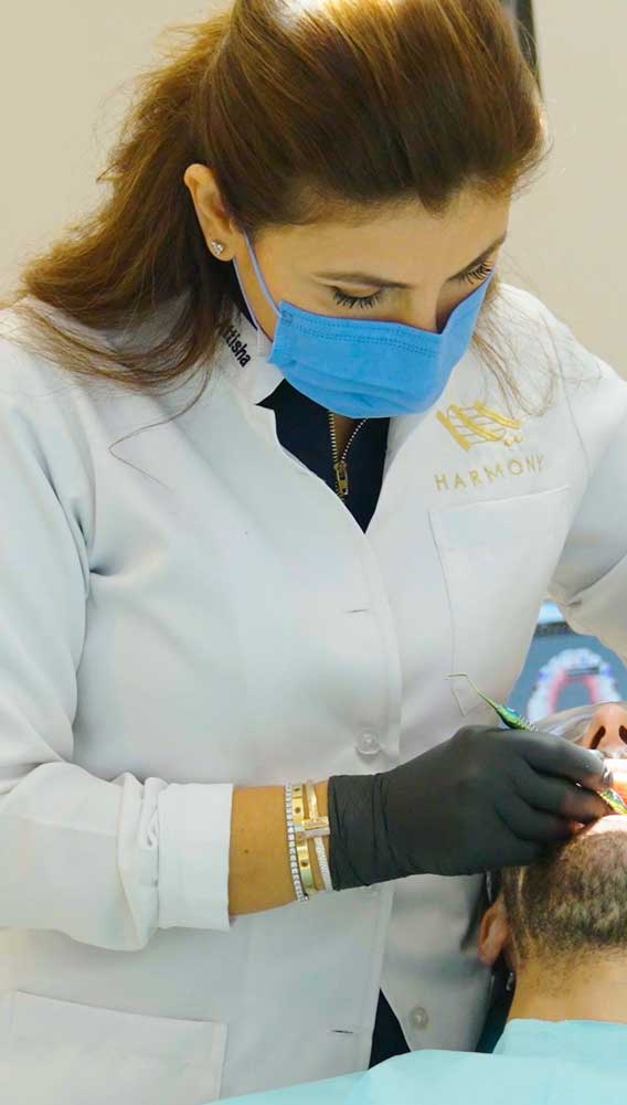 Female general dentist at Harmony Medical Center in Dubai performing a routine dental checkup