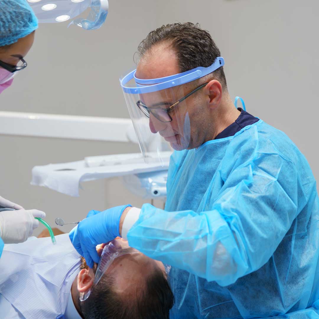 One of Harmony Medical Center's general dentist cleans a patient's cavity and performs a dental filling.