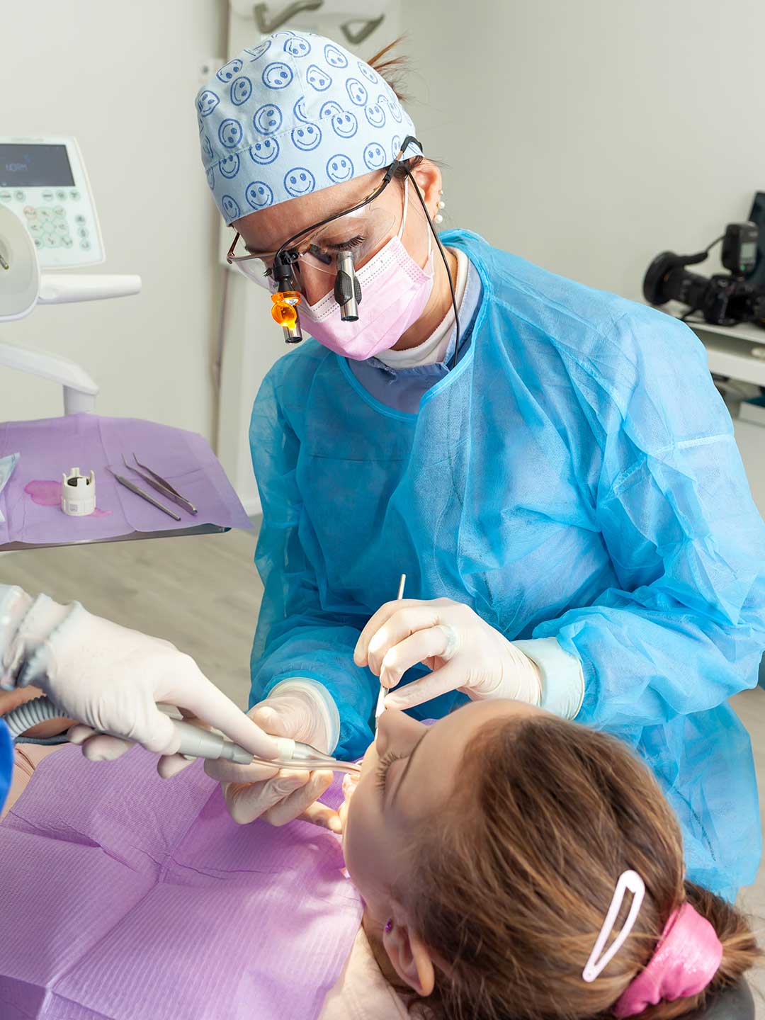 Specialist periodontist at Harmony Medical Center performing gum disease treatment on a female patient.