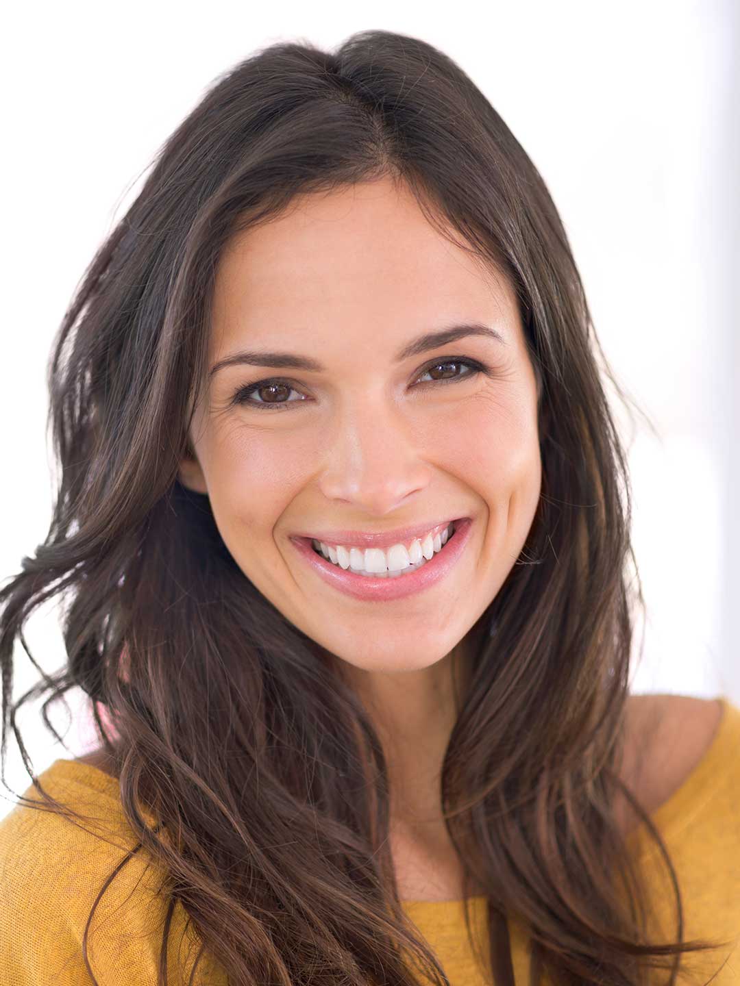 Beautiful woman with a bright white smile after home teeth whitening treatment