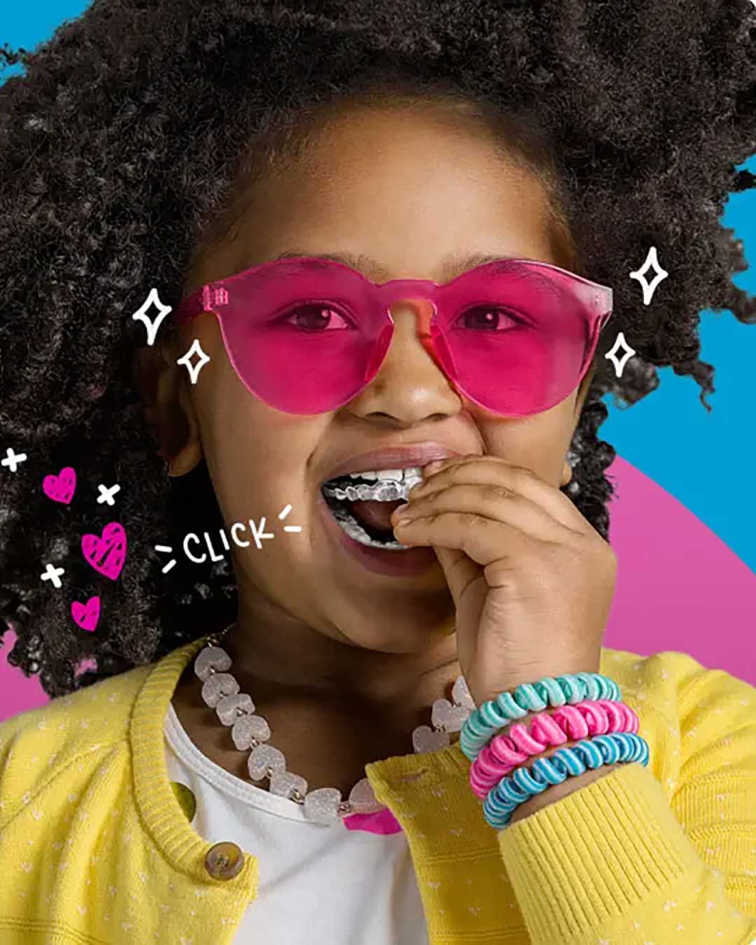 A photo of a little girl wearing Invisalign First clear aligners.